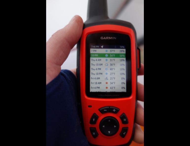 A handheld GPS and satellite communicator delivers a three-day weather forecast. Photo by Ned Rozell.