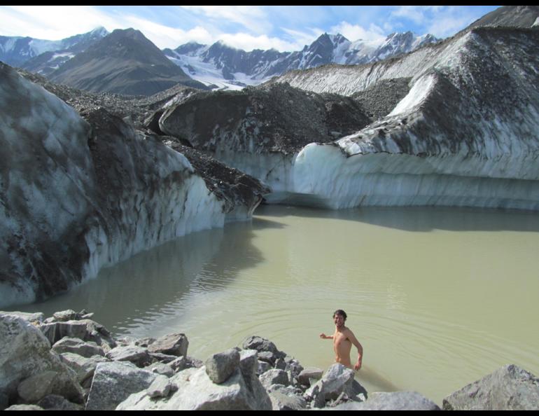 Glacier researcher Sam Herreid baths in a lake on Canwell Glacier in the eastern Alaska Range. Photo by Sam Herreid.