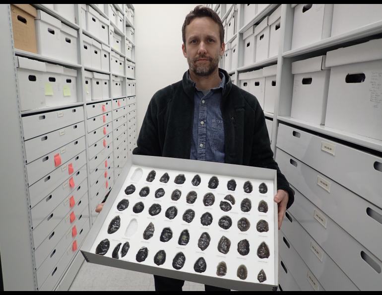 Archeologist Jeff Rasic holds a tray of obsidian tools found in the Nogahabara Dunes west of the Koyukuk River. Photo by Ned Rozell.
