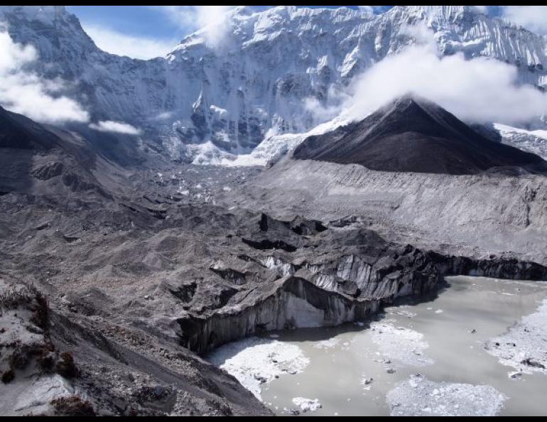 Ice calves into a melt pond from the face of Nepal’s Imja-Lhotse Shar Glacier in June 2016. Photo by David Rounce.