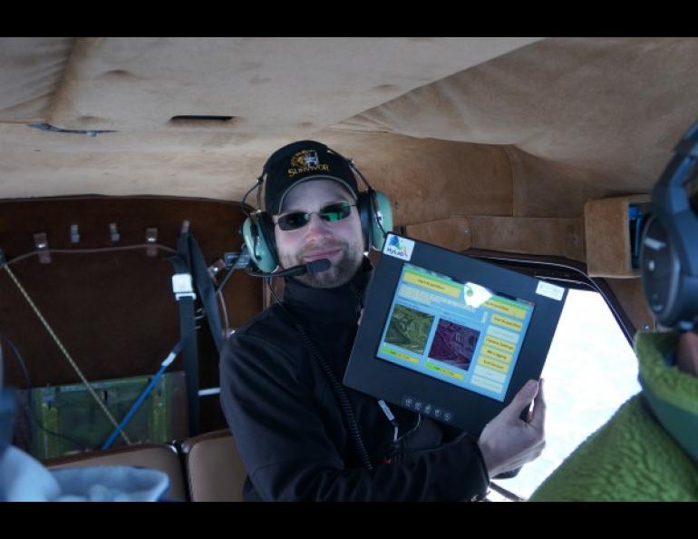 The Geophysical Institute’s Marcel Buchhorn uses a tablet-like touch screen device to control the HySpex instrument during flight. Photo by Patrick Graham.