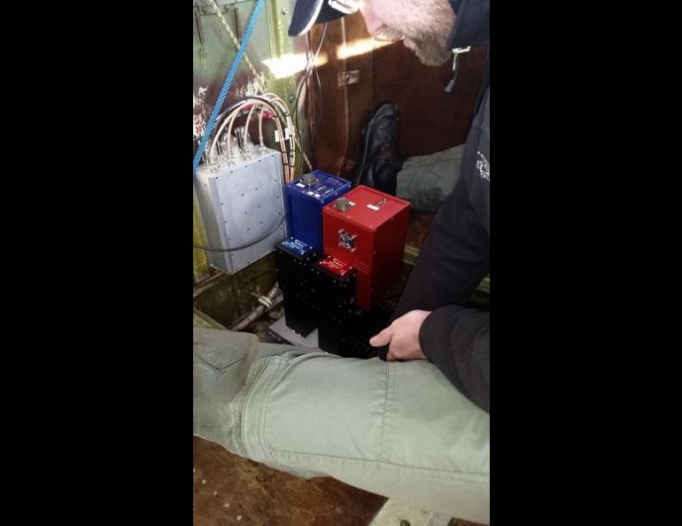 The Geophysical Institute”s Marcel Buchhorn sets up the HySpex sensors inside an aircraft. The HySpex system acquires data from the visible to infrared wavelengths. Photo by Patrick Graham.