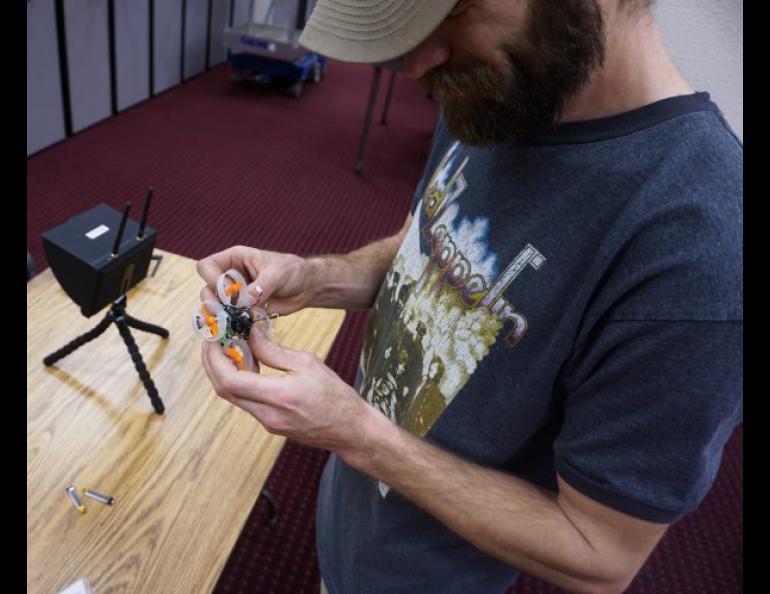 Matthew Westhoff replaces the battery on a drone aircraft in between course runs, which last three to four minutes. UAF photo by Josh Hartman.