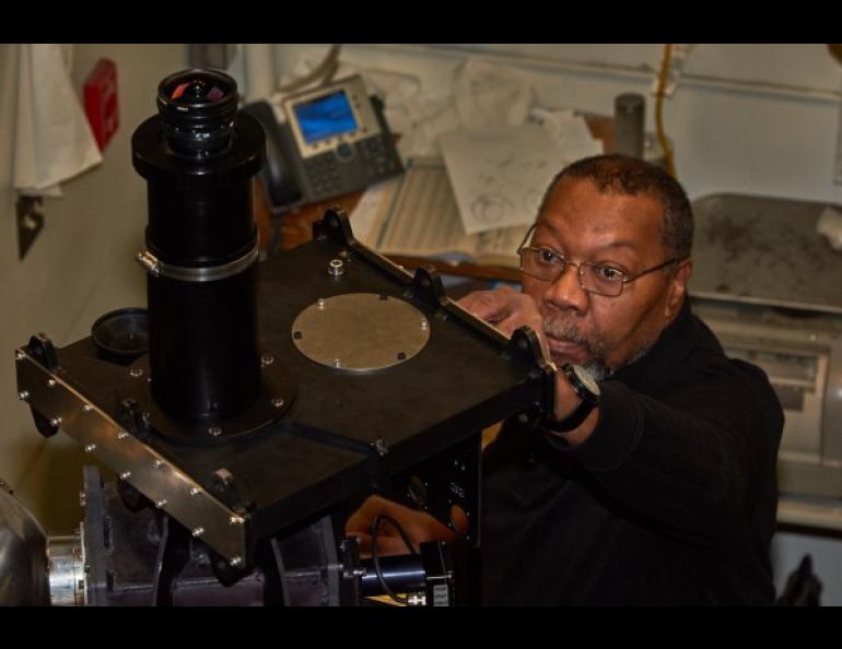 Greg Shipman, Instrument Development Services shop manager at the Geophysical Institute, adjusts a part on the scanning Doppler imager. Photo by Mark Conde.