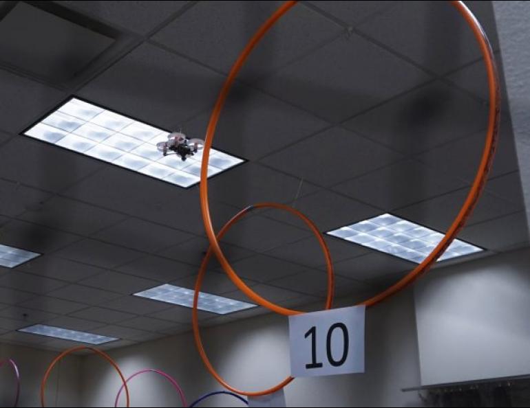 A drone negotiates the 12 brightly colored hula hoops that serve as checkpoints for a drone racing track in the basement of the Akasofu Building. UAF photo by Josh Hartman.