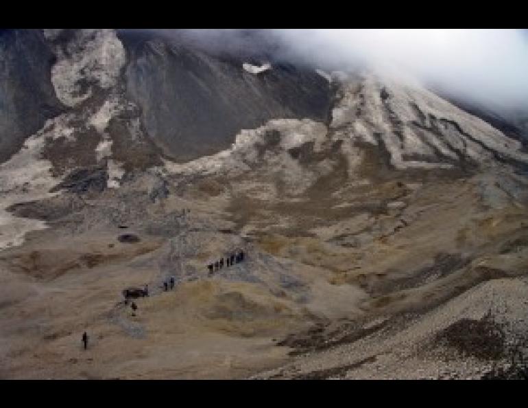 John Eichelberger leads a group of students to the rim of the Katmai caldera in the 2011 International Volcanological Field School. To get there, students must traverse the top of a glacier, insulated by a thick layer of pumice from the massive 1912 eruption of the volcano. Photo by Pavel Izbekov.