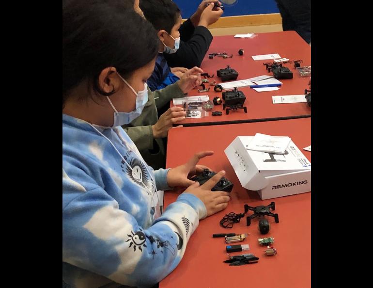 A student at John Fredson School in Venetie, Alaska, works with one of the drone kits provided by the Alaska Satellite Facility through a NASA grant. Photo by Terri Mynatt