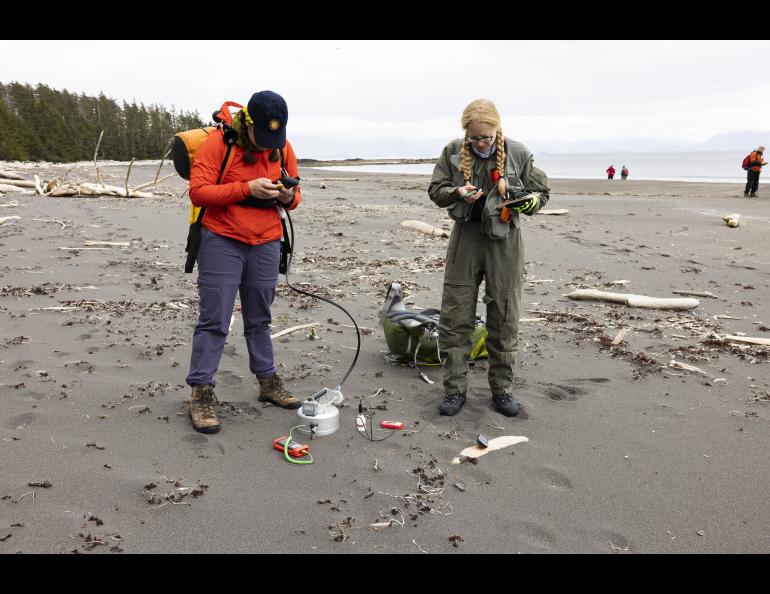 Graduate student researchers Claire Puleio and Valerie Wasser of the UAF Geophysical Institute take ground carbon dioxide measurements and ground and atmospheric readings on a Kruzof Island beach. Photo by JR Ancheta.