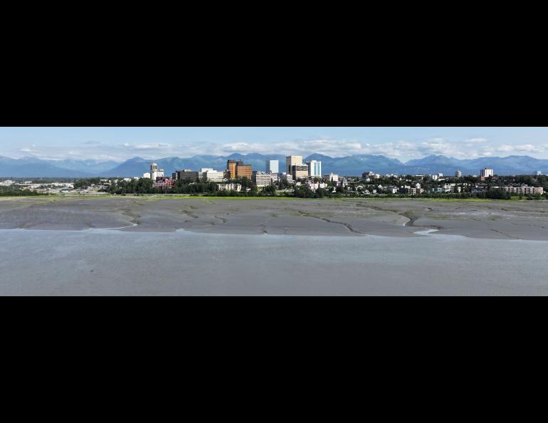  This panorama photograph shows the shallow mudflats and waters of upper Cook Inlet against the municipality of Anchorage. Photo courtesy of the Anchorage mayor’s office.