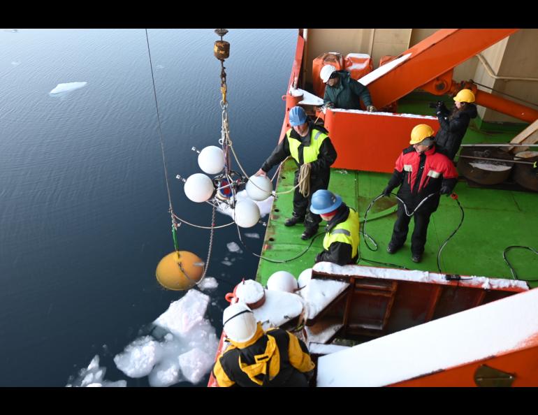 Crew aboard the research vessel Akademik Tryoshnikov hoist science instruments in a 2021 science cruise. Photo courtesy of Igor Polyakov.