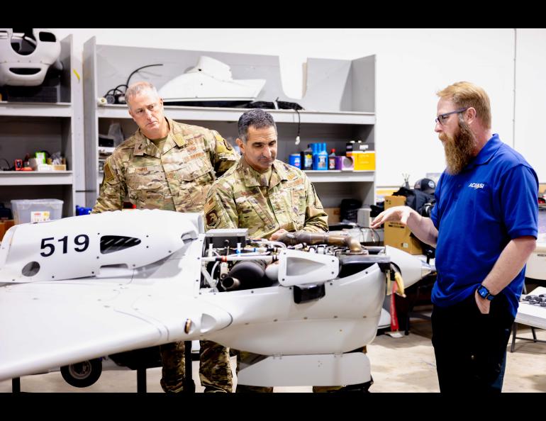 Nick Adkins, deputy director of the Alaska Center for Unmanned Aircraft Systems Integration, explains a Sentry drone to Air Force Lt. Gen. David Nahom, commander of the Alaskan Command, on Aug. 30. UAF/GI Photo by Courtney Holtzclaw.