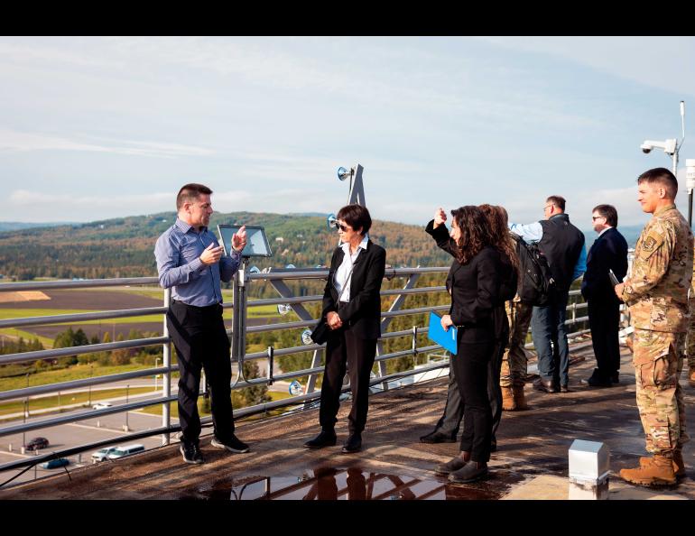 U.S. Undersecretary of Defense Heidi Shyu, center, listens to Alaska Satellite Facility Director Wade Albright on top of the Elvey Building on Aug. 24. Shyu toured the Elvey Building and also the Alaska Center for Unmanned Aircraft Systems Integration hangar. UAF/GI Photo by Courtney Holtzclaw.