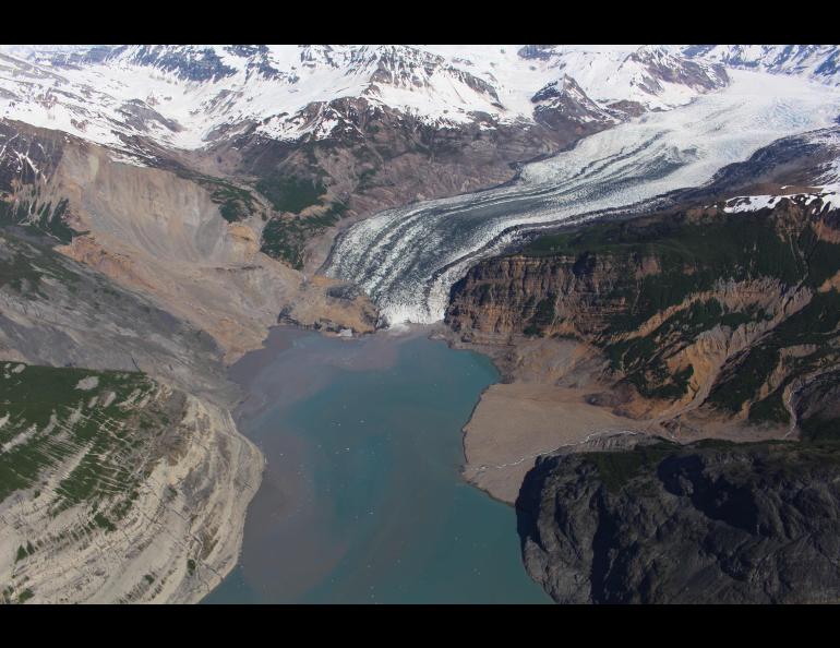 The debris field from an October 2015 landslide extends over the toe of the Tyndall Glacier and into Taan Fjord in spring 2016. Photo by Chris Larsen.