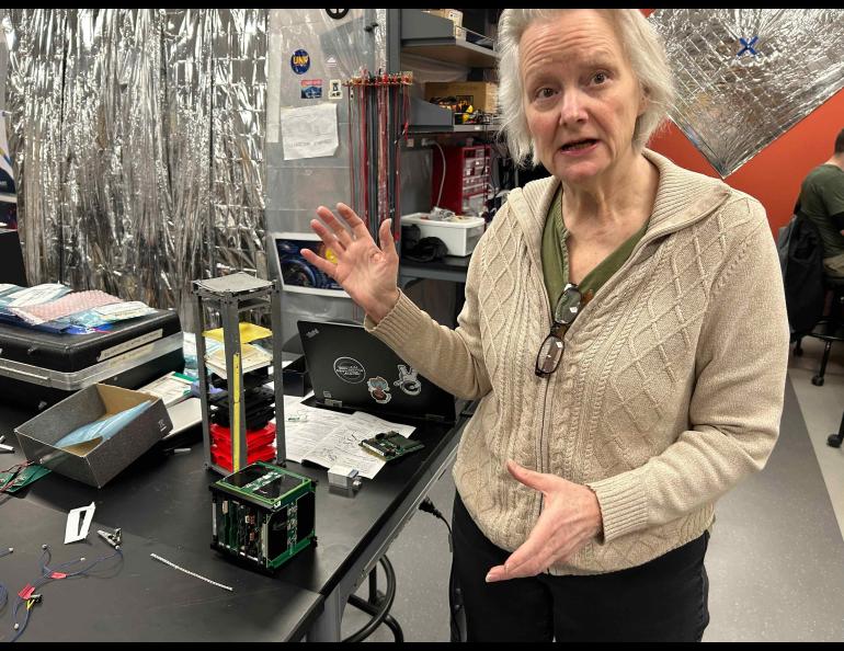 Denise Thorsen explains some of the work underway by students in the University of ϺƵ Fairbanks Space Systems Engineering Program earlier this year. Photo by Rod Boyce.