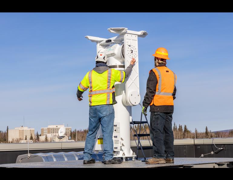 The Geographic Information Network of Alaska (GINA) and UAF Facility Services install a brand new antenna on the roof of the Usibelli Engineering building on Saturday, April 6, 2024. UAF photo by Marina Barbosa Santos