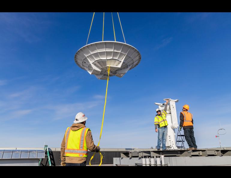 The Geographic Information Network of Alaska (GINA) and UAF Facility Services install a brand new antenna on the roof of the Usibelli Engineering building on Saturday, April 6, 2024. UAF photo by Marina Barbosa Santos