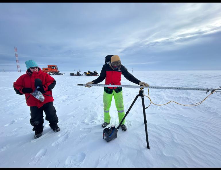 Research Associate Professor Jennifer Delamere, left, watches as UAF employee David Clemens-Sewall sets up the albedometer to measure snow reflectivity. Photo by Rod Boyce