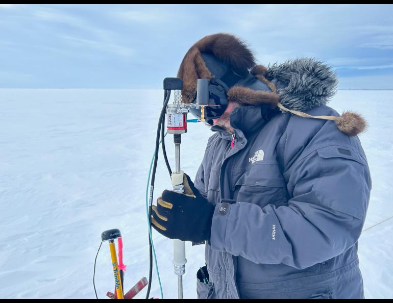 Marc Oggier of the UAF International Arctic Research Center prepares a magnaprobe, which measures snow depth and location of the measurement. Photo by Rod Boyce