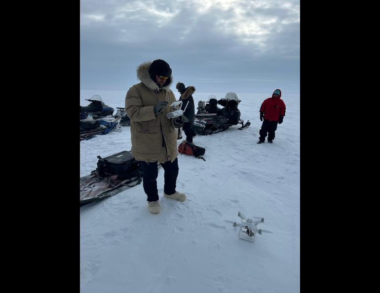 Phillip Wilson, research professional at the UAF Institute of Northern Engineering, prepares to use a drone to take measurements along a defined line. Photo by Rod Boyce