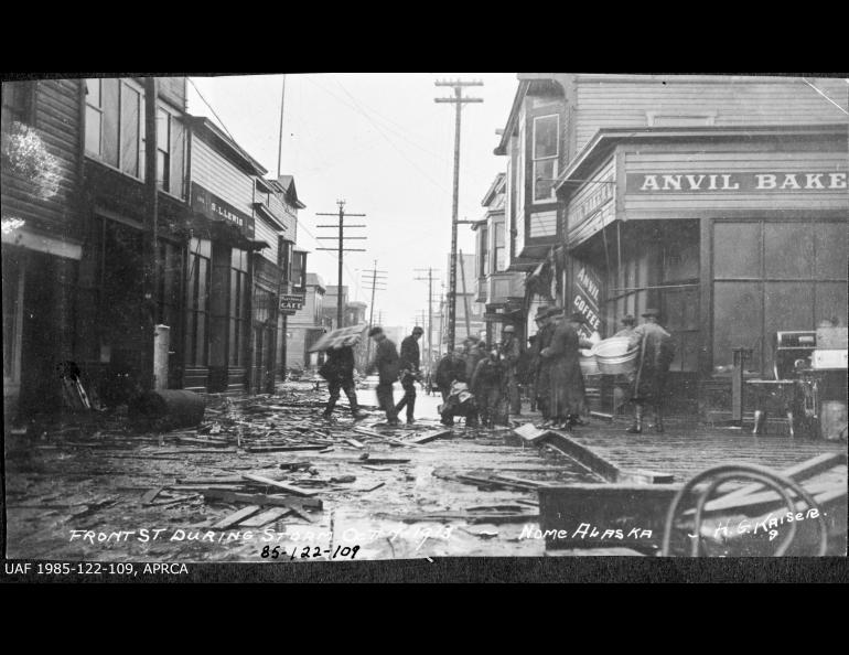 This photograph shows Front Street in Nome, Alaska, during a storm on Oct. 7, 1913. Anvil Bakery, Anvil Coffee Shop, Merchants Cafe and S.L.Lewis clothing store are visible. UAF archive