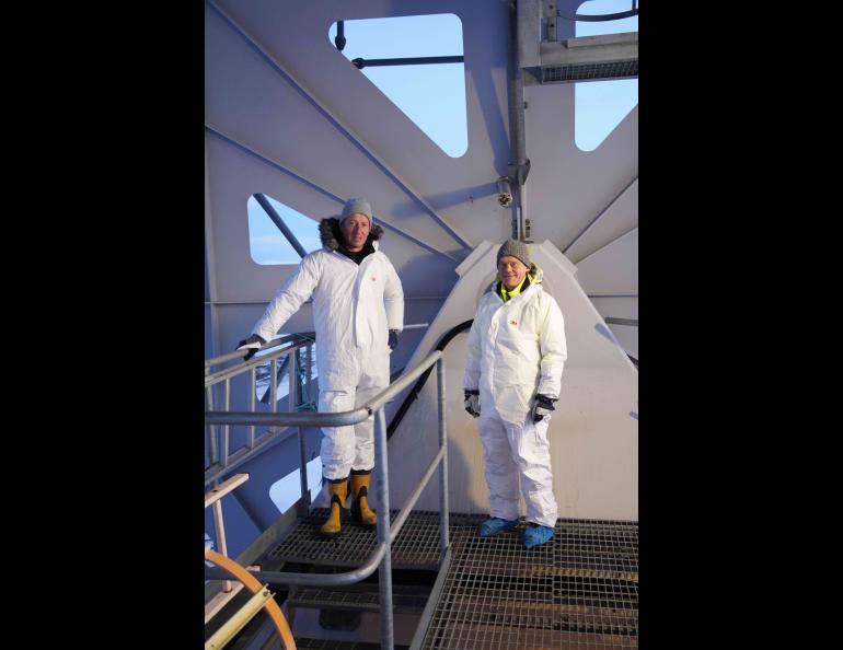 Incoming EISCAT Director Axel Steuwer, left, and outgoing Director Craig Heinselman stand at the EISCAT 32-meter steerable antenna at the Longyearbyen, Svalbard site on Nov. 2, 2022. Photo courtesy Craig Heinselman