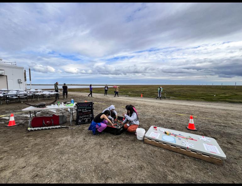 Elementary school students digging in the ‘Permafrost Exploration Sled’ while at the BARC Science & Culture Fair in August 2024. Photo by Serina Wesen