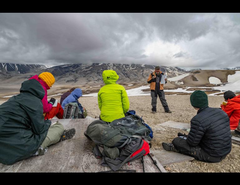 Research associate professor Pavel Izbekov of the University of Alaska Fairbanks Geophysical Institute gives a mineralogy lecture at the remains of the Baked Mountain Hut, a research facility destroyed by wind. Photo by Seth Adams