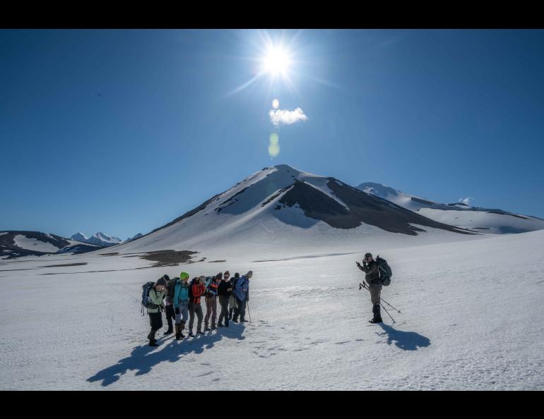 Research associate professor Pavel Izbekov photographs students on the return from a day hike with Novarupta in the background. Photo by Seth Adams