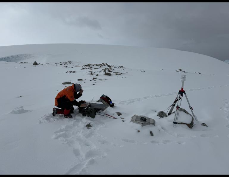 A field engineer of the Wilson Alaska Technical Center at the UAF Geophysical Institute services a portable infrasound monitoring station near Palmer Station, Antarctica. Photo courtesy of the Wilson Alaska Technical Center.