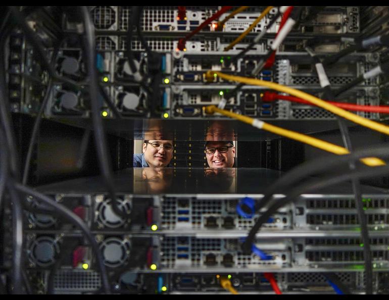 Kevin Galloway, left, Linux systems analyst and Mike Steinhauer, Linux system administrator of the University of Alaska Fairbanks Geophysical Institute Research Computing Systems peer through a rack containing a portion of the high performance computing cluster Chinook. Photo by LJ Evans 