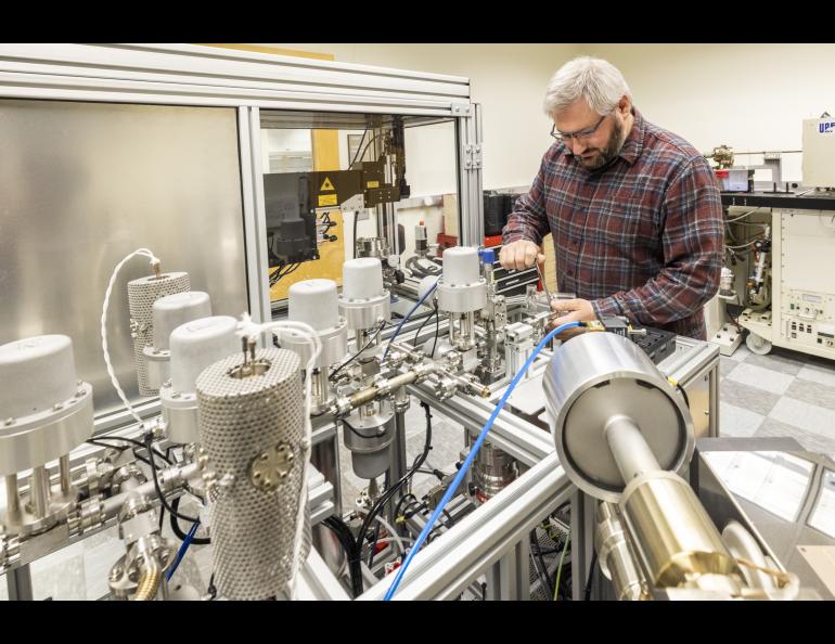  Research assistant professor Florian Hofmann of the UAF Geophysical Institute’s Geochronology Lab works on the lab’s argon mass spectrometer. Photo by JR Ancheta