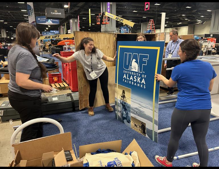 Setting up the UAF Research booth. Photo by Rod Boyce