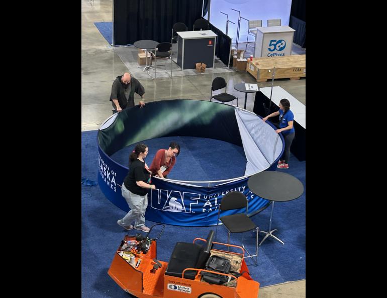 Getting the new UAF halo ready to be hoisted to the ceiling. Photo by Rod Boyce