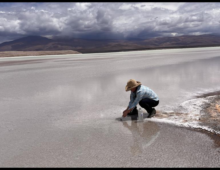 Lee Ann Munk samples the surface at a closed-basin brine in Argentina in 2023. Photo courtesy of Lee Ann Munk