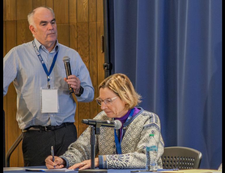 Mark Myers, commissioner of the U.S. Arctic Research Commission, leads a discussion on the potential of geologic hydrogen at a conference in Fairbanks recently. Alaska State Senator Cathy Giessel takes notes. Photo by Eric Marshall.