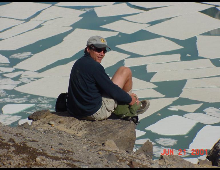 Ned Rozell sits at the edge of the volcanic crater on Mount Katmai during a trip to the Valley of 10,000 Smokes in 2001. Photo by John Eichelberger.