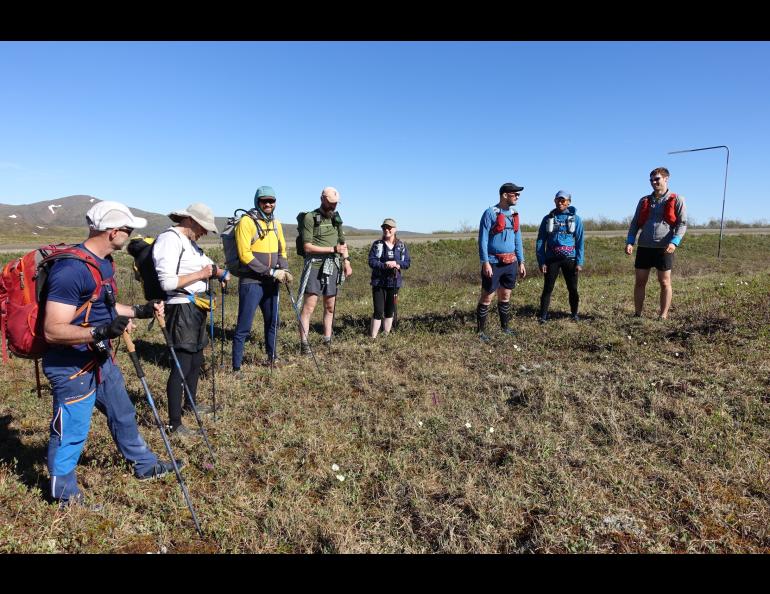 Competitors in the AlaskAcross 2024 race prepare to depart from Eagle Summit at 10 a.m. on June 8, 2024. From left are Bruno Grunau, Mark Ross, Forest Wagner, Mike Fisher, Sarah Hurkett, Clinton Brown, Tracie Curry and Curtis Henry. Photo by Ned Rozell.