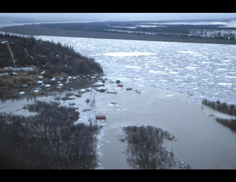  An ice jam in the lower Yukon backed the river into the village of Russian Mission in 1989. Floodwaters remained in the village for one week, when the only way in or out was by helicopter. Photo by Larry Rundquist, Alaska-Pacific River Forecast Center. 