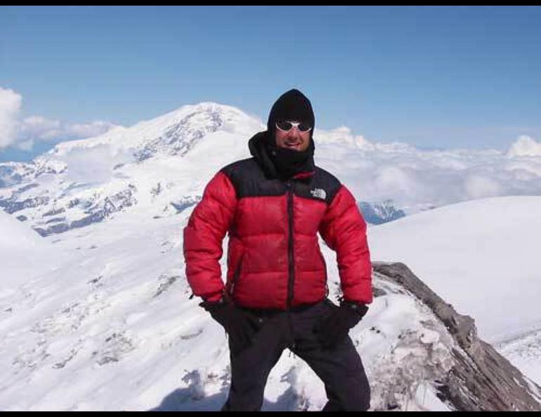  Anthony Arendt exploring a crater on Mount Wrangell, with Mount Sanford in the background. Photo by Martin Luthi. 