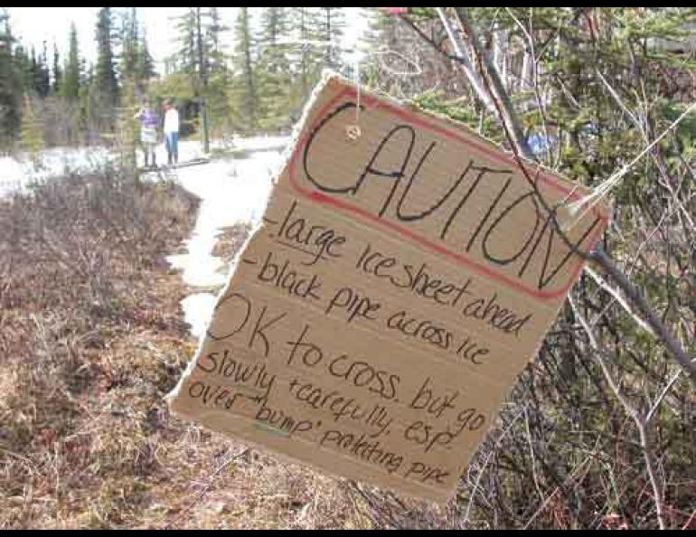  A resident of the Goldstream Valley north of Fairbanks installed this sign warning trail users of a small glacier that formed in her yard. Photo by Ned Rozell. 