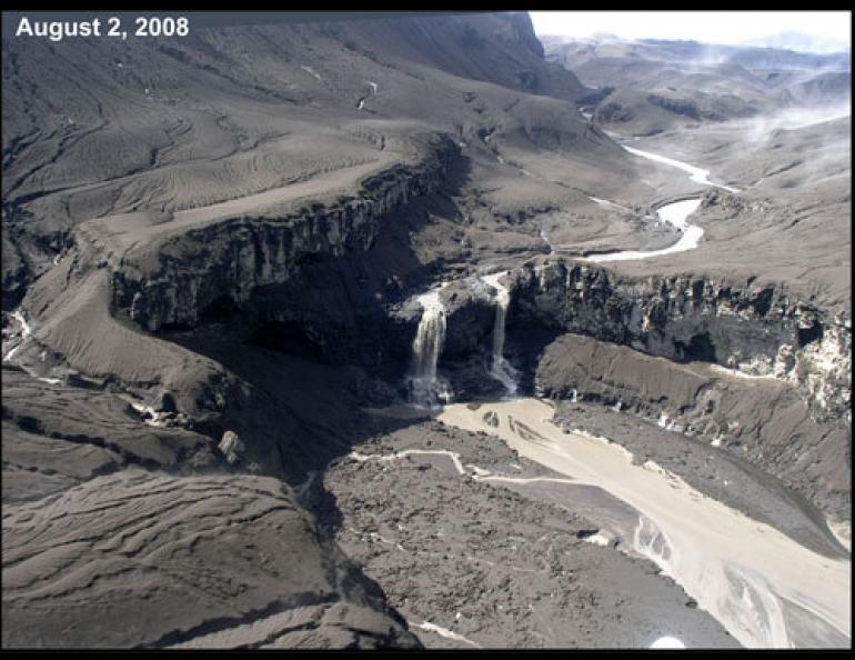  The falls on Umnak Island’s Crater Creek, in 2004, and in 2008, covered with ash after the recent eruption of Okmok volcano. Photos/illustration by Janet Schaefer, Alaska Volcano Observatory, Alaska Division of Geological and Geophysical Surveys. 