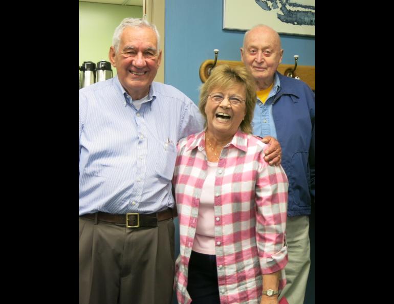 Glenn Shaw celebrates a retirement with his friends Val Scullion and Carl Benson (standing at back) at the Geophysical Institute in 2014. Photo by Ned Rozell.