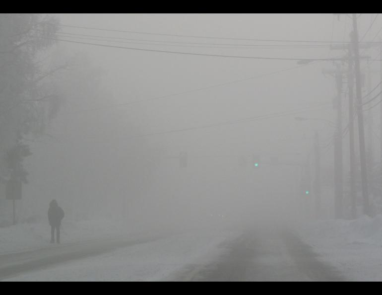 A man walks a Fairbanks street during an ice-fog episode in January 2012. Photo by Ned Rozell.