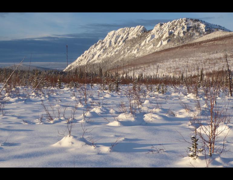 The Big Bend rock formation in the White Mountains National Recreation Area north of Fairbanks catches sunlight on Jan. 23, 2022.