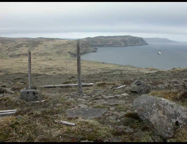 A Shinto shrine remains on Kiska Island after a brief Japanese occupation during World War II. The Alaska Maritime National Wildlife Refuge’s ship, the Tiglax, floats in the background. Photo by Ned Rozell.