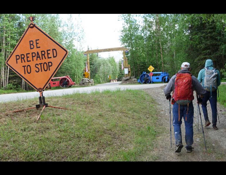 Bruno Grunau, left, and Forest Wagner approach the entryway to Chena Hot Springs Resort and the conclusion of their 50-mile, 33-hour foot journey from Eagle Summit. Photo by Ned Rozell.