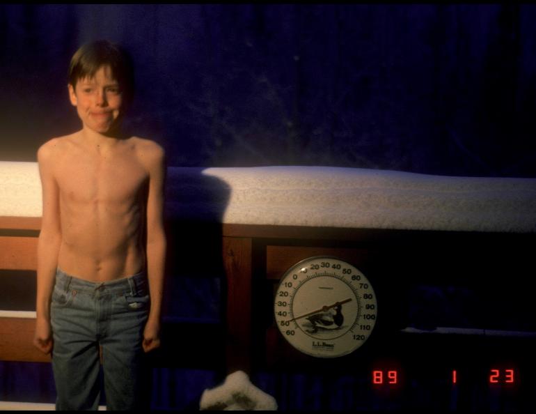 A 9-year-old Carl Tape — now a seismologist at UAF’s Geophysical Institute — poses beside a thermometer registering 50 below zero Fahrenheit during a Fairbanks cold snap in January 1989. Photo by Walt Tape.