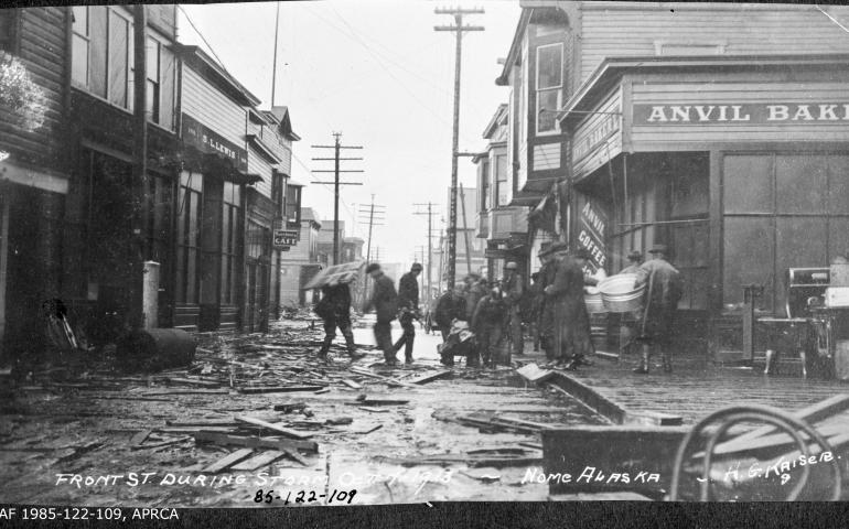 This photograph shows Front Street in Nome, Alaska, during a storm on Oct. 7, 1913. Anvil Bakery, Anvil Coffee Shop, Merchants Cafe and S.L.Lewis clothing store are visible. UAF archive