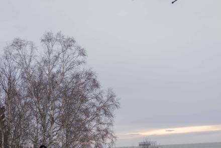 Chief pilot Jason Williams of the Alaska Center for Unmanned Aircraft Systems Integration, at right, controls a drone carrying the science instruments during a test flight Jan. 17, 2025. Research assistant professor Társilo Girona watches. Photo by Eric Marshall