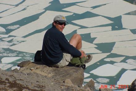 Ned Rozell sits at the edge of the volcanic crater on Mount Katmai during a trip to the Valley of 10,000 Smokes in 2001. Photo by John Eichelberger.